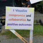 A demonstrator holds a sign at a rally Sunday, July 28, 2019, against Gov. Mike Dunleavys budget cuts at the Legislative Information Office, Homer, Alaska. (Photo by Michael Armstrong/Homer News).