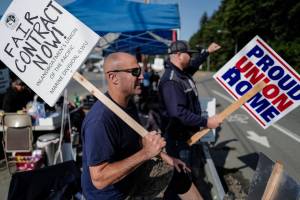 John Vercessi, left, and Dave Bell man the picket line for the Inlandboatmens Union of the Pacific at the Alaska Marine Highway Systems Auke Bay Terminal on Tuesday, July 30, 2019. Vercessi works as a seaman on the MV LeConte and Bell is a relief boatswain. (Michael Penn | Juneau Empire)