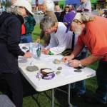 Recall Dunleavy organizer Kathy Carssow takes signatures at a Recall Dunleavy rally held on Aug. 1, 2019, at WKFL Park in Homer, Alaska. (Photo by Michael Armstrong)