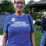 Michele Vasquez wears a profane guttersnipes for justice T-shirt at a Recall Dunleavy rally held on Aug. 1, 2019, at WKFL Park in Homer, Alaska. The slogan comes from a Republican Party reference to people who protested a Wasilla Middle School during the special session held earlier in July. Vasquez and her husband, Larry Simmons, visited Homer from Soldotna and stopped by the rally to sign recall petitions. (Photo by Michael Armstrong)