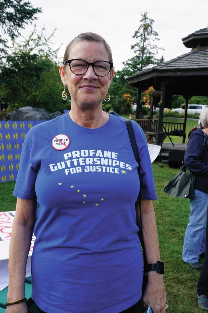 Michele Vasquez wears a profane guttersnipes for justice T-shirt at a Recall Dunleavy rally held on Aug. 1, 2019, at WKFL Park in Homer, Alaska. The slogan comes from a Republican Party reference to people who protested a Wasilla Middle School during the special session held earlier in July. Vasquez and her husband, Larry Simmons, visited Homer from Soldotna and stopped by the rally to sign recall petitions. (Photo by Michael Armstrong)