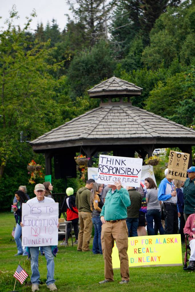 Recall Dunleavy supporters hold signs at a Recall Dunleavy rally held on Aug. 1, 2019, at WKFL Park in Homer, Alaska. (Photo by Michael Armstrong)