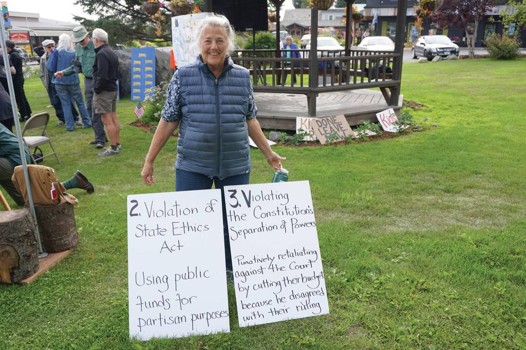 Recall Dunleavy supporter Shelley Gill holds signs listing the reasons to reacll Gov. Mike Dunleavy at a Recall Dunleavy rally held on Aug. 1, 2019, at WKFL Park in Homer, Alaska. (Photo by Michael Armstrong)