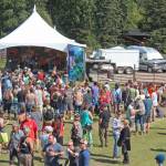 Festival goers listen to a performance at the River Stage on Saturday, Aug. 3, 2019 at Salmonfest in Ninilchik, Alaska. (Photo by Megan Pacer/Homer News)
