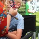 Iver Ledahl, 8, of Kenai, gets his face painted on Friday, Aug. 2, 2019 at Salmonfest in Ninilchik, Alaska. (Photo by Megan Pacer/Homer News)