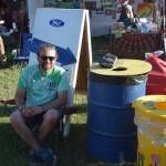 Zero Waste Volunteer Organizer Ryan Astalos smiles for the camera at one of the waste disposal stations during Salmonfest 2019 in Ninilchik, Alaska on August 2, 2019. (Photo by Brian Mazurek/Peninsula Clarion)