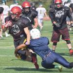 Photo by Jeff Helminiak/Peninsula Clarion                                 Zach Burnett of Kenai Central runs against Homer during a scrimmage Saturday, Aug. 10, at Ed Hollier Field in Kenai.