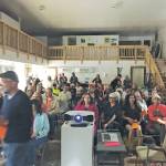 Photo by Brianna Allen                                 The audience waits for the start of a PechaKucha 20x20 presentation on July 25 at The Shop: Kachemak Bay Art Space.