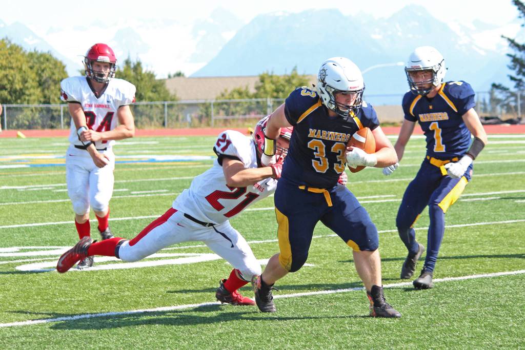 Photo by Megan Pacer/Homer News                                 Kenai Central High Schools Zach Burnett tackles Homer High Schools Kamden Doughty during their first regular football game of the season Saturday, Aug. 17, 2019 in Homer, Alaska.