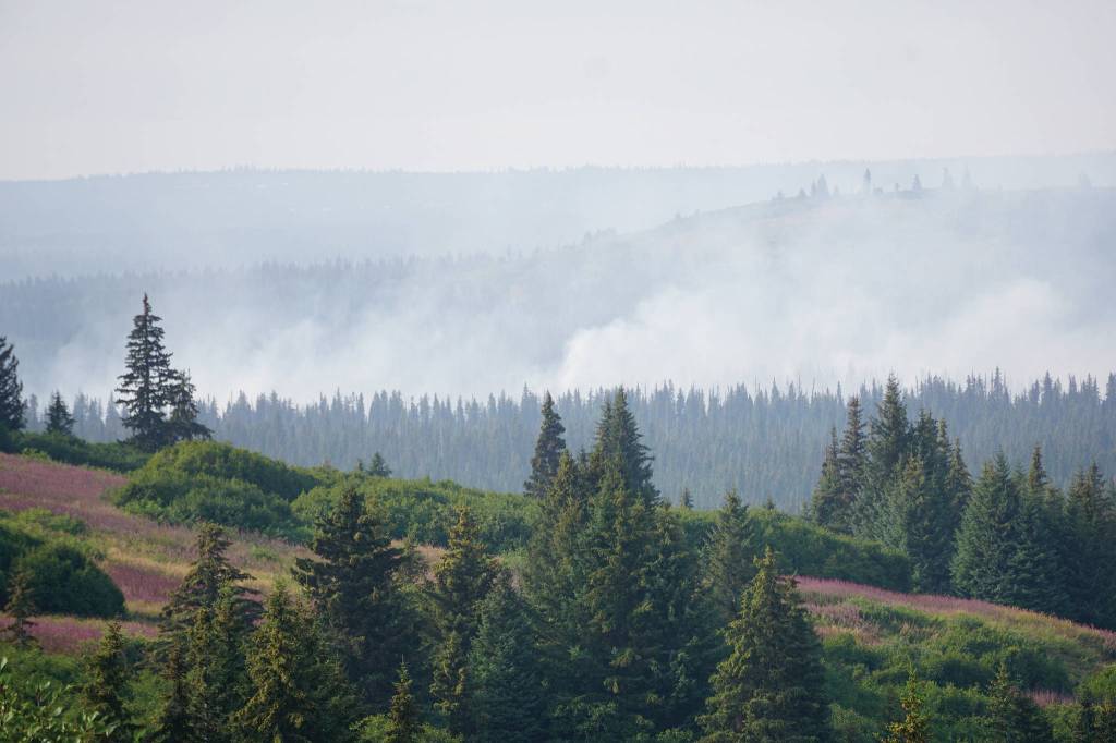 The North Fork fire burns near the south end of the North Fork Road on Monday evening, Aug. 19, 2019, near Homer, Alaska, as seen from Diamond Ridge Road. Smoke is blowing from the southwest and along the Anchor River valley. (Photo by Michael Armstrong/Homer News)