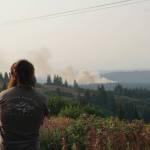 Diamond Ridge resident Parick Buongiorne watches the North Fork fire as it burns near the south end of the North Fork Road on Sunday evening, Aug. 18, 2019, near Homer, Alaska, as seen from Diamond Ridge Road. Buongiorne had previously worked as a wildlife firefighter with the Pioneer Peak crew. (Photo by Michael Armstrong/Homer News)