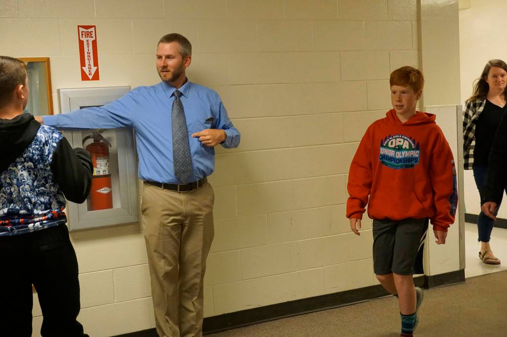 Music teacher Eric Simonson directs students to band and choir classes at the start of the new school year on Tuesday, Aug. 20, 2019, at Homer Middle School in Homer, Alaska. (Photo by Michael Armstrong/Homer News)
