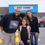 Nelton Palma, left, and Megan Palma, right, pose with their daughter Aria after the start of her first day on Tuesday, Aug. 20, 2019, at West Homer Elementary School in Homer, Alaska. (Photo by Michael Armstrong/Homer News)