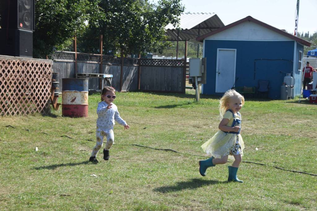 Attendees of the Kenai Peninsula Fair enjoy the music of Crabshoot on Saturday, Aug. 17, 2019 at the fairgrounds in Ninilchik, Alaska. (Photo by Brian Mazurek/Peninsula Clarion)