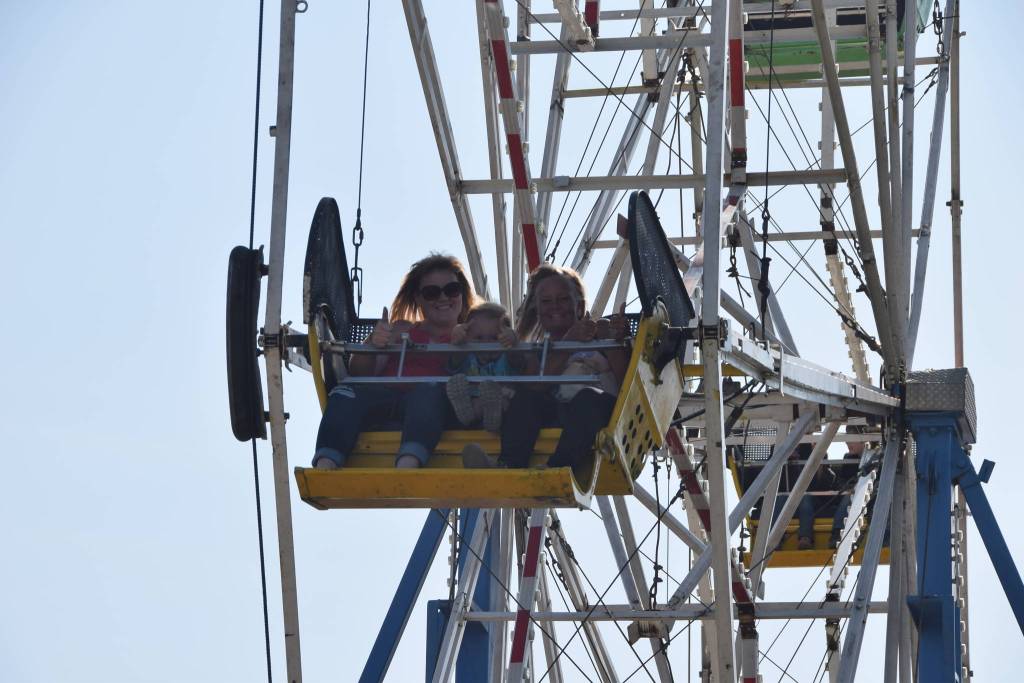 Attendees of the Kenai Peninsula Fair smile for the camera on Saturday, Aug. 17, 2019 at the fairgrounds in Ninilchik, Alaska. (Photo by Brian Mazurek/Peninsula Clarion)
