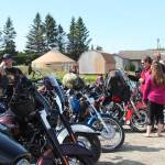 Bike riders and community members look at the myriad motorcycles assembled for the inaugural Homer Suicide Awareness and Prevention Ride and Drive on Saturday, Aug. 17, 2019 starting at the Homer Christian Church on East End Road in Homer, Alaska. (Photo by Megan Pacer/Homer News)