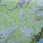 A map shows the Caribou Lake Fire, in red, in relationship to nearby communities and cabins. It was part of a community meeting held on Saturday, Aug. 24, 2019, at a McNeil Canyon Elementary School near Fritz Creek, Alaska. (Photo by Michael Armstrong/Homer News)
