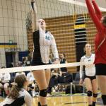 Nikiski volleyball player Kaycee Bostic tips the ball over the net to the Kenai Kardinals during a Saturday, Aug 24, 2019 game during the Homer Jamboree tournament in the Alice Witt Gymnasium in Homer, Alaska. (Photo by Megan Pacer/Homer News)