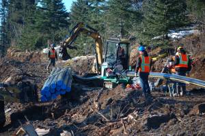 Workers with Chumleys General Contractors lay and weld pipe near Mile 166 Sterling Highway several miles north of Diamond Ridge Road during construction of the Anchor Point-Homer natural gas trunk line in April 2013, near Homer, Alaska. (Homer News file photo)