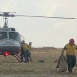 Firefighters unload supplies from a helicopter at the Caribou Lake Fire on Monday, Aug 26, 2019, northeast of Homer, Alaska. (Photo by Sarah Saarloos/Alaska Division of Forestry)
