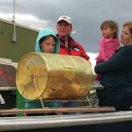 Jack and Ben Engebretsen, sons of Bay Weld general manager Erik Engebretsen, draw the winning ticket for the Homer Chamber of Commerce and Visitor Center Bay Well skiff contest as chamber board secretary Kari Dendurent, center, and chamber executive director Debbie Speakman, with daughter Alice, watch. The drawing was held on Sept. 2, 2019, at Grace Ridge Brewery in Homer, Alaska. (Photo provided)