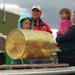 Jack and Ben Engebretsen, sons of Bay Weld general manager Erik Engebretsen, draw the winning ticket for the Homer Chamber of Commerce and Visitor Center Bay Well skiff contest as chamber board secretary Kari Dendurent, center, and chamber executive director Debbie Speakman, with daughter Alice, watch. The drawing was held on Sept. 2, 2019, at Grace Ridge Brewery in Homer, Alaska. (Photo provided)