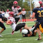 Homers Josh Manwiller (53) tackles Houston running back Owen Mulhaney during a Friday, Sept. 6, 2019 football game at the Mariner field in Homer, Alaska. (Photo by Megan Pacer/Homer News)