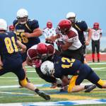 Homer quarterback Anthony Kalugin (12) tackles Houstons Kennedy Fono during a Friday, Sept. 6, 2019 football game between the two teams on the Mariner field in Homer, Alaska. (Photo by Megan Pacer/Homer News)