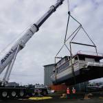 Operators of an Alaska Crane Liebherr LTM 1500 mobile hydraulic crane move the Goldbelt Seawolf at its launch on Tuesday, Sept. 10, 2019, at the Northern Enterprises Boatyard in Homer, Alaska. (Photo by Michael Armstrong/Homer News)
