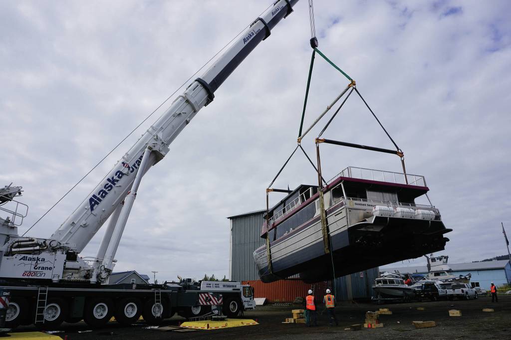 Operators of an Alaska Crane Liebherr LTM 1500 mobile hydraulic crane move the Goldbelt Seawolf at its launch on Tuesday, Sept. 10, 2019, at the Northern Enterprises Boatyard in Homer, Alaska. (Photo by Michael Armstrong/Homer News)