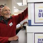 Vic Fischer, the last living person to help write the Alaska State Constitution, is shown smiling while looking at boxes of signatures to recall Alaska Gov. Mike Dunleavy that were delivered to the Alaska Division of Elections office in Anchorage on Thursday, Sept. 5. Fischer is one of the recall organizers, who say they submitted 49,0006 signatures in in an attempt to force the recall election of the first-term governor. (AP Photo/Mark Thiessen)