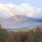 A rainbow can be seen next to rising smoke from the Swan Lake Fire in this photo released Thursday, Sept. 5. (Courtesy Kenai Peninsula Borough Office of Emergency Management)