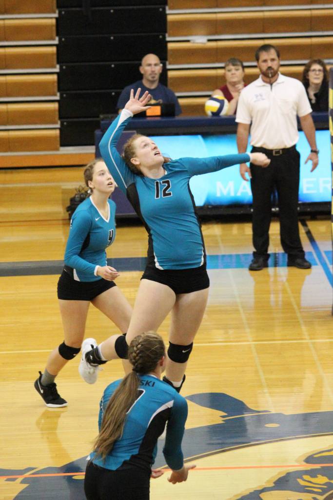 Nikiskis Kaycee Bostic jumps to spike the ball during a Saturday, Sept. 14, 2019 volleyball game against Homer High School in the Alice Witte Gymnasium in Homer, Alaska. (Photo by Megan Pacer/Homer News)