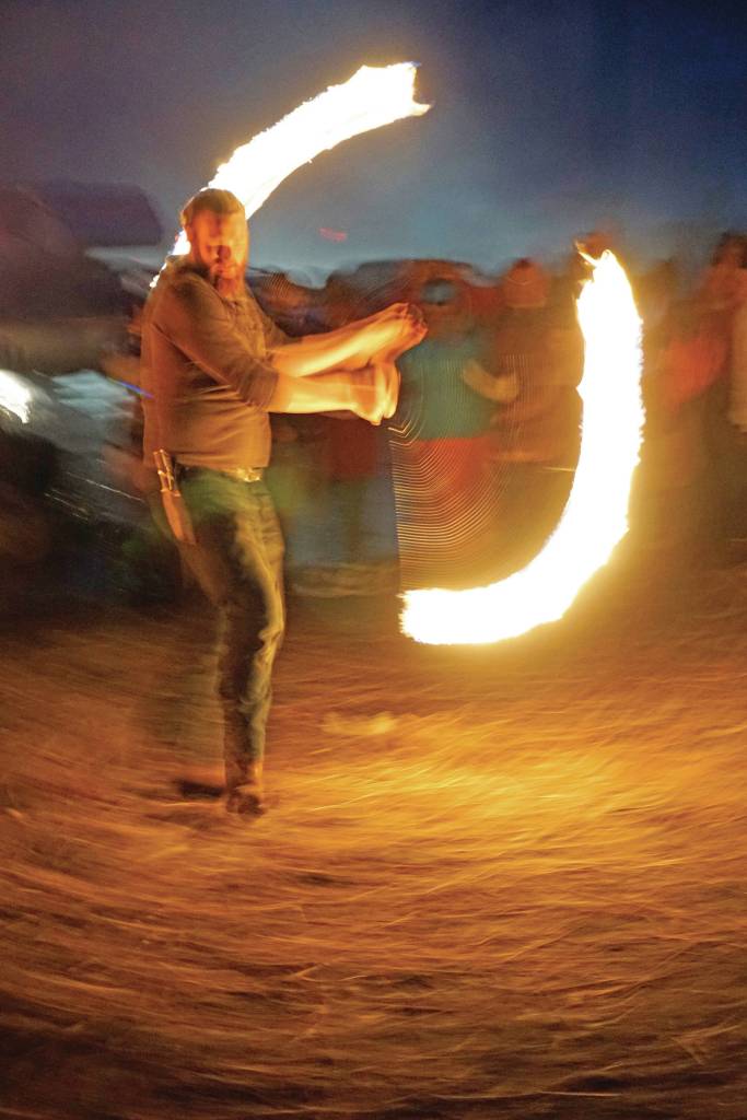 Aaron Stillwell spins fire at Radiate, the 16th annual Burning Basket, as it burns down on Sunday night, Sept. 15, 2019, at Mariner Park on the Homer Spit in Homer, Alaska. (Photo by Michael Armstrong/Homer News)