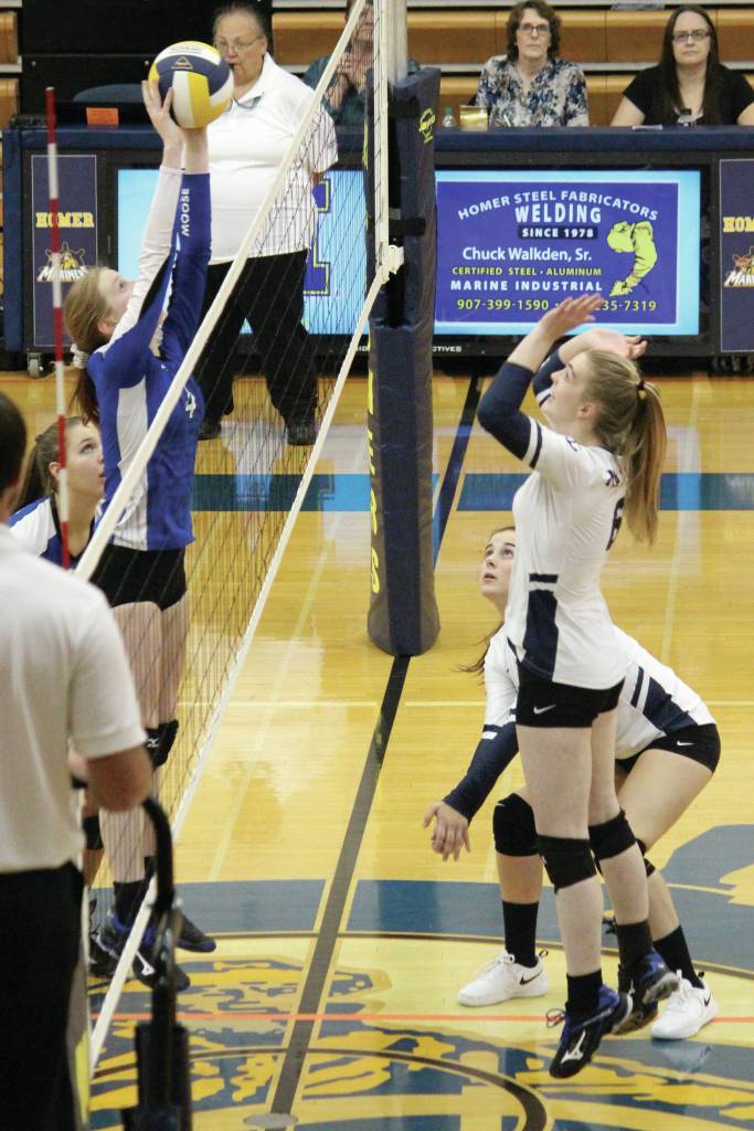 Homers Karmyn Gallios jumps to block a tip from Palmers Deana McNutt during a Thursday, Sept. 12, 2019 volleyball game at the Alice Witte Gymnasium in Homer, Alaska. (Photo by Megan Pacer/Homer News)
