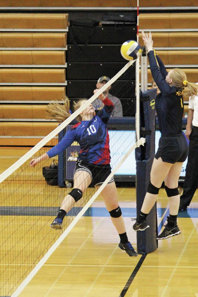 Photo by Megan Pacer/Homer News                                 Kira Keller of Anchorage Christian Schools meets Homers Kelli Bishop at the net during a Saturday, Sept. 28 volleyball game in the Alice Witte Gymnasium in Homer.