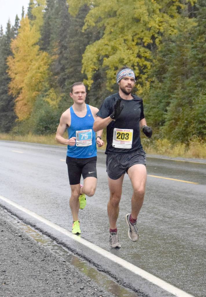 Photo by Jeff Helminiak/Peninsula Clarion                                 Anchorages Marshall Genn leads Soldotnas Jason Parks on Sunday, Sept. 29, 2019, at the Kenai River Marathon in Alaska. Genn won the Half Marathon, while Parks won the Marathon.