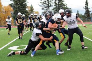 Homers Antonin Maruchev powers through a group of Nikiski defenders during a Saturday, Sept. 28, 2019 football game at Homer High School in Homer, Alaska. (Photo by Megan Pacer/Homer News)
