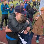 Homers Autumn Daigle hugs a family member after winning the Div. II girls state cross-country championship Saturday, Oct. 5, 2019, on the Bartlett High trails in Anchorage, Alaska. (Photo by Joey Klecka/Peninsula Clarion)