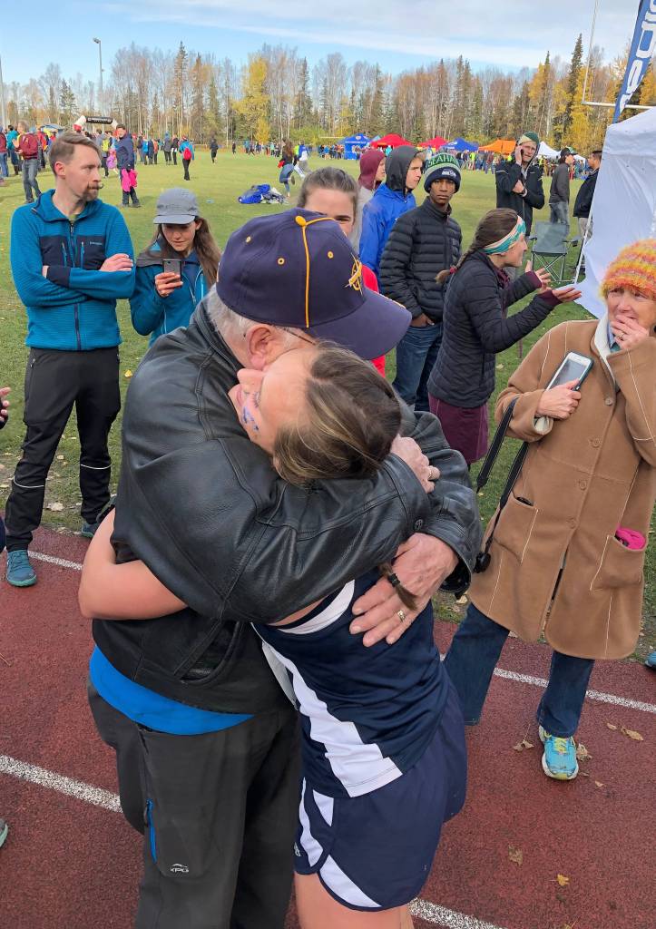 Homers Autumn Daigle hugs a family member after winning the Div. II girls state cross-country championship Saturday, Oct. 5, 2019, on the Bartlett High trails in Anchorage, Alaska. (Photo by Joey Klecka/Peninsula Clarion)