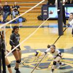 Homers Laura Inama dives for a ball that was blocked by Soldotnas Serena Foglia and Sierra Kuntz during a Tuesday, Oct. 8, 2019 volleyball game at the Alice Witte Gymnasium in Homer, Alaska. (Photo by Megan Pacer/Homer News)