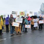 Local supporters of the effort to recall Gov. Mike Dunleavy protest outside the Lands End Resort where he gave a brief presentation on the statewide economy at a conference held by the Alaska State Home Building Association and the Kenai Peninsula Home Builders Association on Thursday, Oct. 17, 2019 in Homer, Alaska. (Photo by Megan Pacer/Homer News)