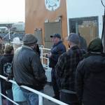 A group of community members gets briefs before they embark on a trip through the Haunted Hickory, a haunted house set up on the US Coast Guard Cutter Hickory vessel, on Friday, Oct. 25, 2019 at the harbor in Homer, Alaska. (Photo by Megan Pacer/Homer News)