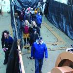 A member of the Haunted Hickory waits around the corner to scare a group of guests at the haunted house set up on the US Coast Guard Hickory on Friday, Oct. 25, 2019 on the vessel at the harbor in Homer, Alaska. (Photo by Megan Pacer/Homer News)