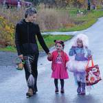 Carla Cope, left, leads ?? and ?? for Halloween trick-or-treating on Bayview Avenue on Oct. 31, 2019, in Homer, Alaska. (Photo by Michael Armstrong/Homer News)