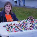 Molly Graham hands out pipecleaner spiders she made on Bayview Avenue on Oct. 31, 2019, in Homer, Alaska. (Photo by Michael Armstrong/Homer News)