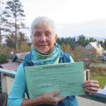 Fair Share Act sponsor Jane Angvik holds an initiative petition booklet she delivered to Homer, Alaska, on Oct. 25, 2019. (Photo by Michael Armstrong/Homer News)