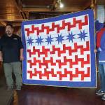 Iraq War veteran Robert R.J. Carlough stands with a Quilt of Valor presented to him at the Veterans Day lunch held at the Elks Lodge on Nov. 11, 2019, in Homer, Alaska. Carlough served in the U.S. Army First Division, 16th Infantry  the Big Red One  from 2002-10, and in Iraq from 2003-04. To his right is Karrie Youngblood, who quilted the work. (Photo by Michael Armstrong/Homer News)