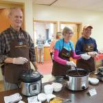 From left to right, Wim Steenbakkers, Deb Smith and Ray Quintana serve soup at the annual Homer Community Food Pantrys Empty Bowls fundraiser on Friday, Nov. 8, 2019, at Homer United Methodist Church in Homer, Alaska. Quintana was visiting from Albuquerque, New Mexico, and volunteered his time during this stay. (Photo by Michael Armstrong/Homer News)