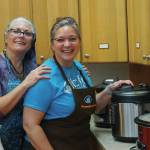 Susan Pacillo, left, and Cinda Martin, right, warm up soup at the annual Homer Community Food Pantrys Empty Bowls fundraiser on Friday, Nov. 8, 2019, at Homer United Methodist Church in Homer, Alaska. (Photo by Michael Armstrong/Homer News)
